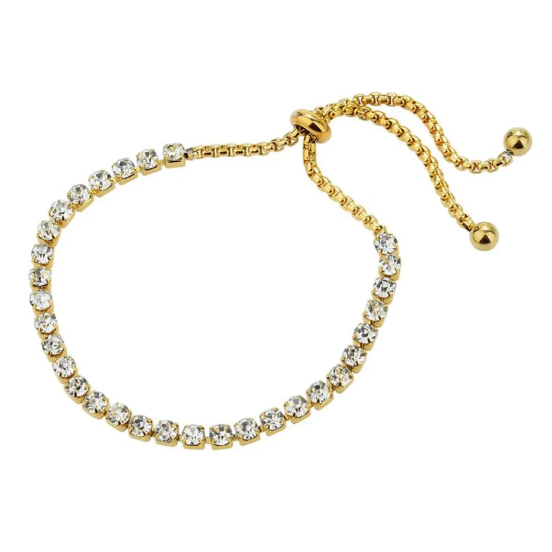 Elegant gold bracelet with clear sparkling stones and adjustable sliding clasp on white background