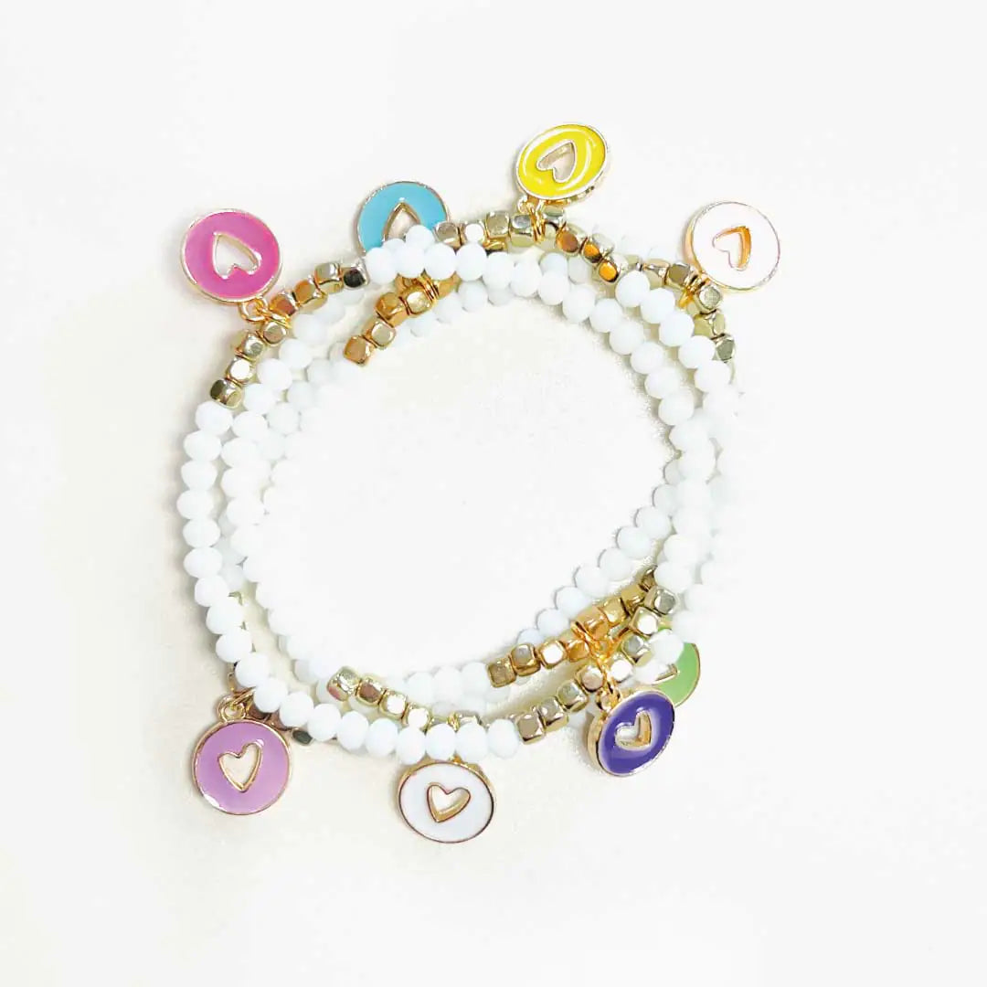 Set of white beaded bracelets with gold and colorful heart charms, luxury fashion accessory