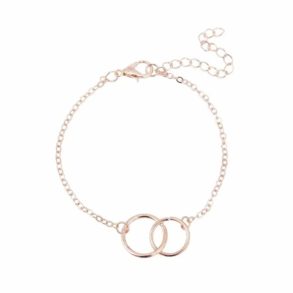 Delicate rose gold chain bracelet with two interlocking circles, adjustable clasp closure