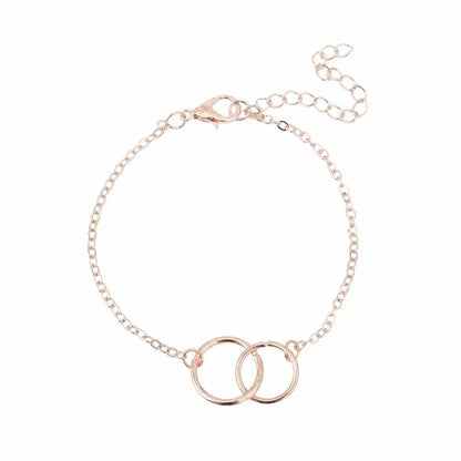 Delicate rose gold chain bracelet with two interlocking circles, adjustable clasp closure
