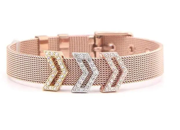 Rose gold mesh bracelet with gold, silver, and rose gold crystal arrow charms on white background