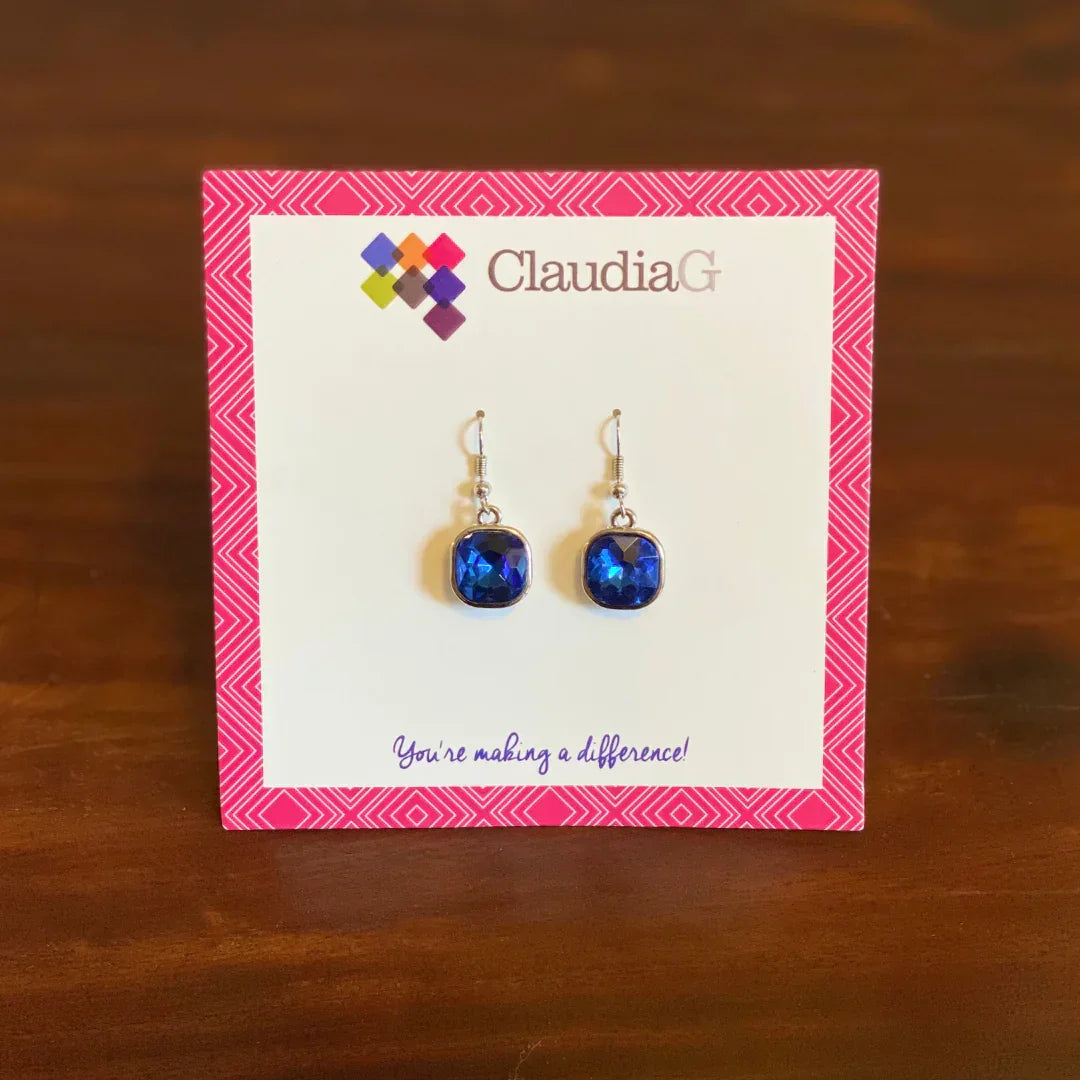 ClaudiaG brand blue faceted gemstone dangle earrings on pink patterned display card