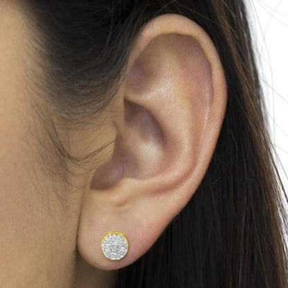 Close-up of an ear wearing a gold stud earring with multiple small white gemstones from Azure Jewelry