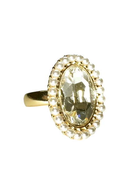 Gold ring with large oval clear gemstone surrounded by small white pearls from Azure Jewelry