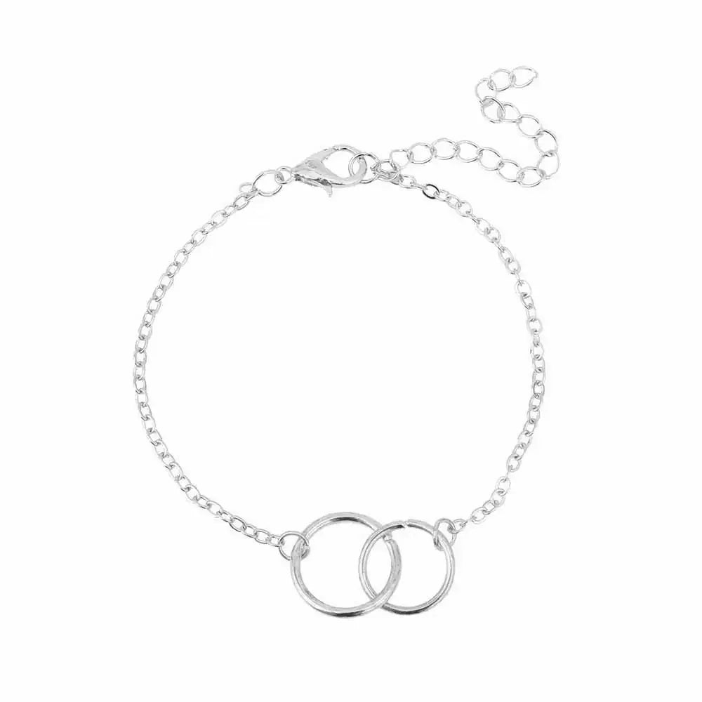 Silver bracelet with two interlocking rings on delicate chain, adjustable clasp closure