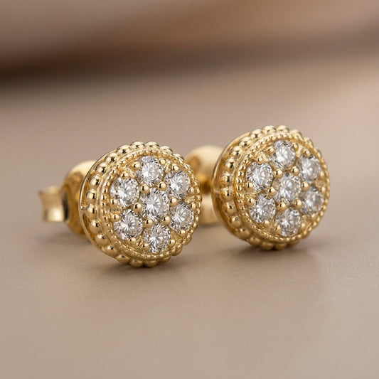 Gold stud earrings with cluster of sparkling white gemstones, vintage-inspired design on beige background