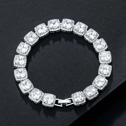 Elegant silver bracelet featuring large square-cut cubic zirconia stones with small sparkling accents on black background