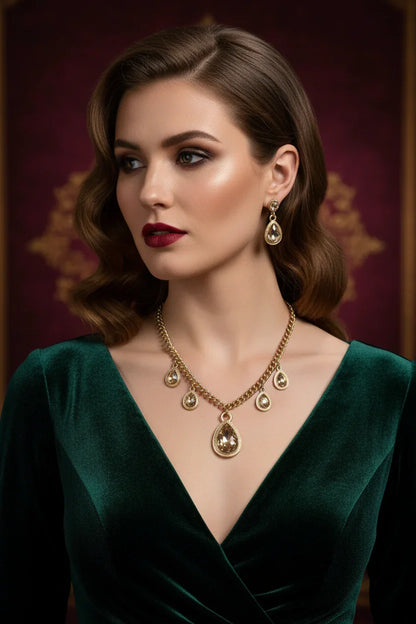 Elegant woman in emerald velvet dress wearing gold crystal drop necklace and matching earrings
