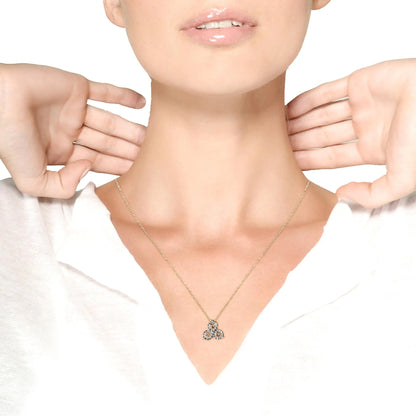 Close-up of a woman wearing a delicate gold necklace with a triple round diamond pendant on a white background