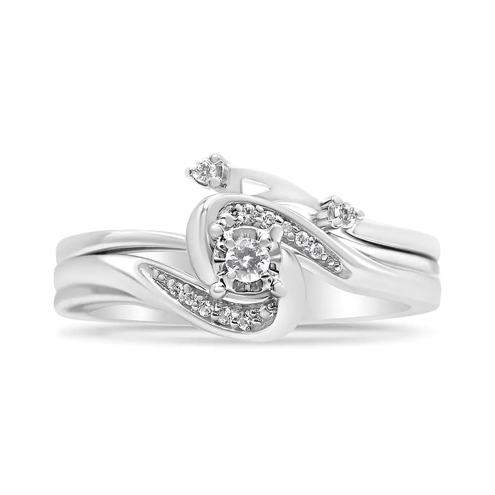 Elegant silver bridal ring with central round diamond and small accent diamonds in swirling design