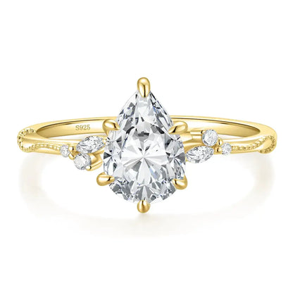 Elegant 18k gold ring with a large pear-shaped diamond and smaller marquise and round diamonds