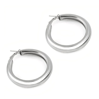 Pair of polished silver hoop earrings with secure clasps on white background