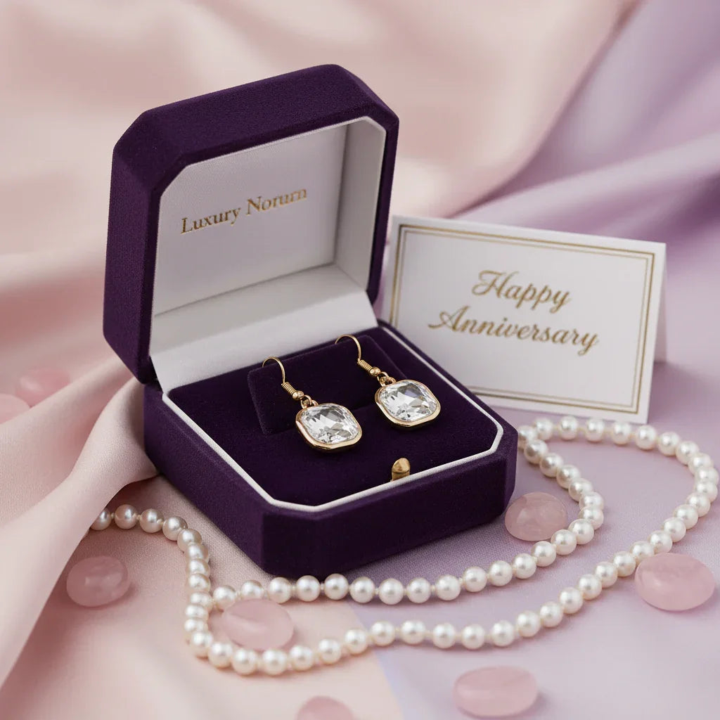 Square crystal earrings in gold setting displayed in purple velvet luxury gift box with pearl necklace and Happy Anniversary card
