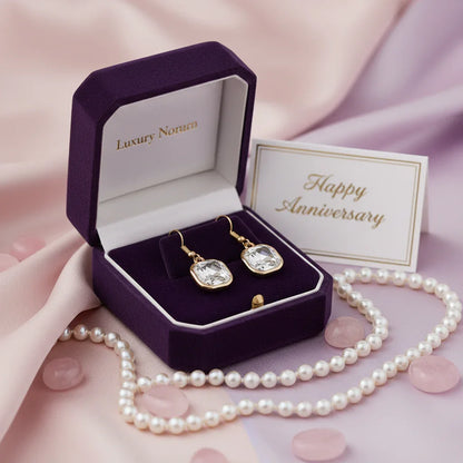 Square crystal earrings in gold setting displayed in purple velvet luxury gift box with pearl necklace and Happy Anniversary card