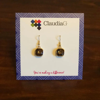 Black faceted drop earrings displayed on a branded card with geometric border and text
