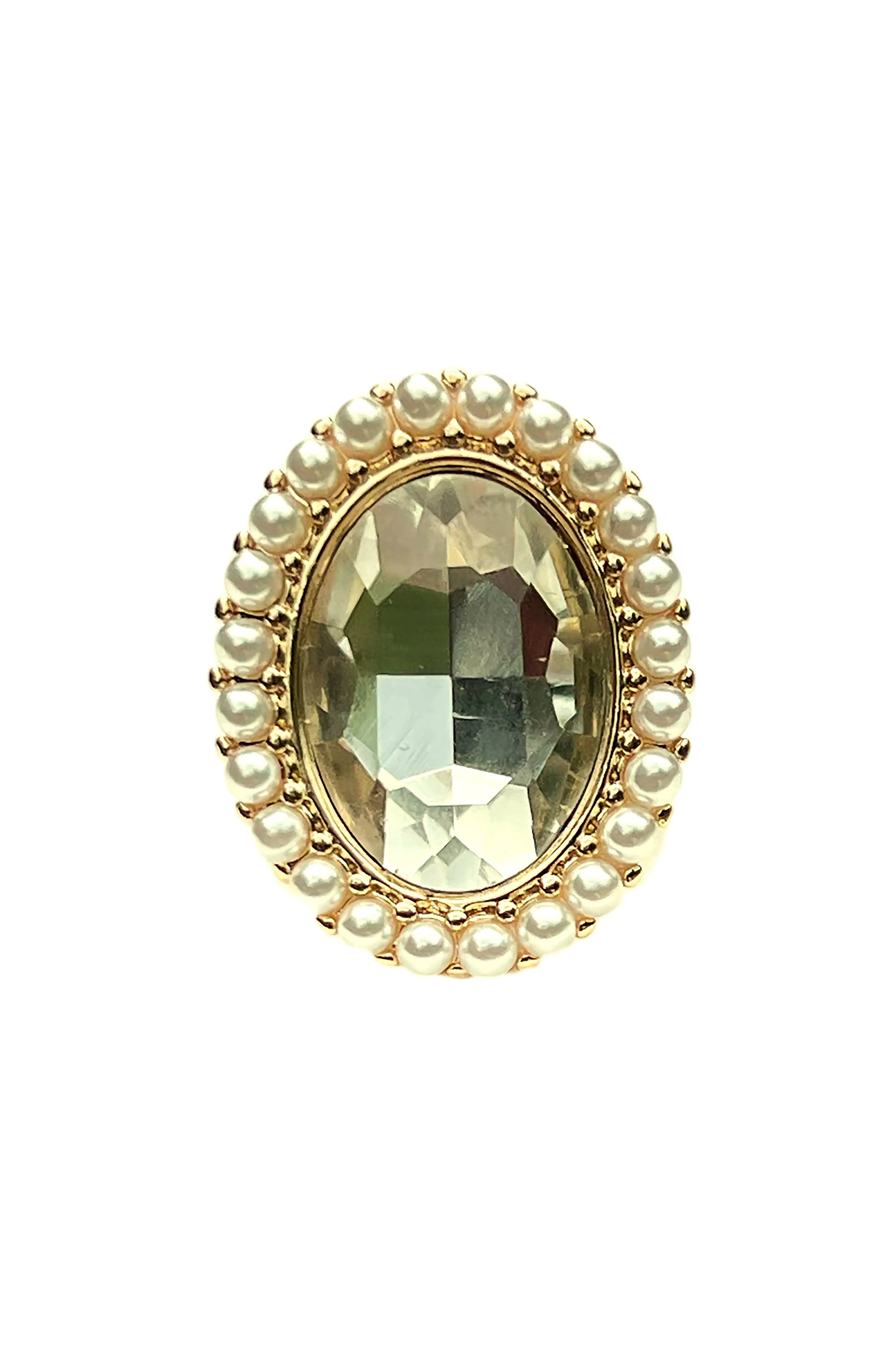 Oval faceted green gemstone ring surrounded by small pearls set in gold jewelry